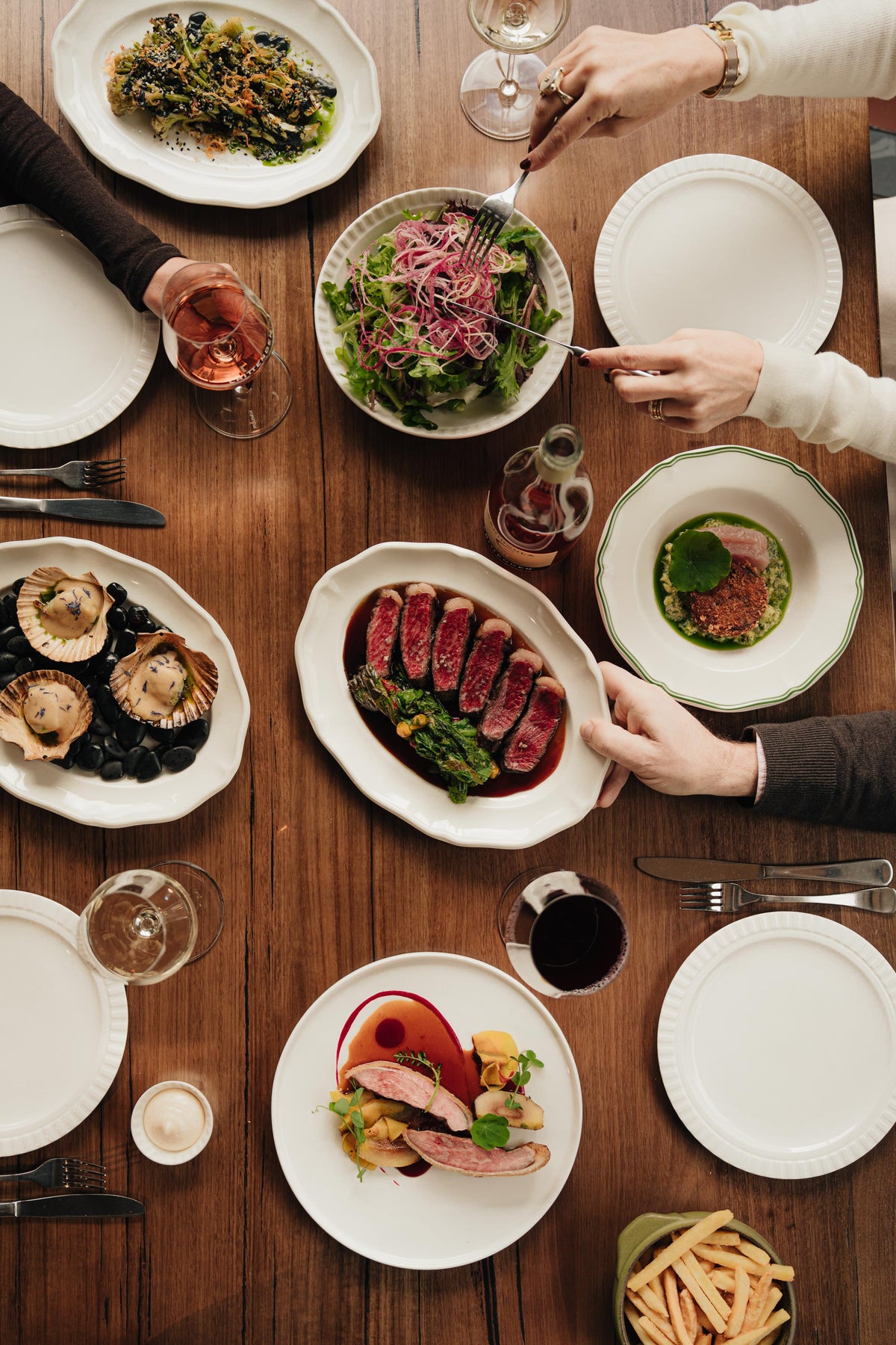 Shared dishes on a restaurant table seen from above