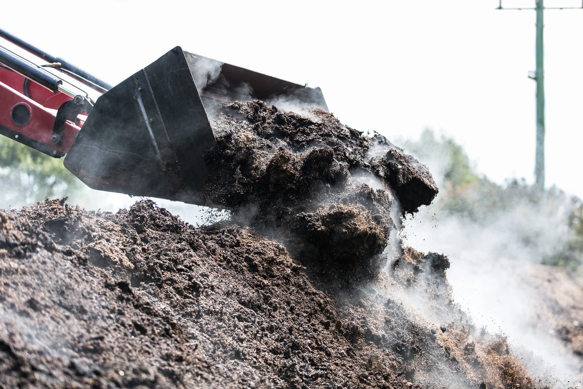 Compost being turned over by a digger at Crittenden's sustainably farmed vineyard