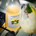 Bottle of Crittenden Pinocchio Limoncello with a glass of limoncello in the background