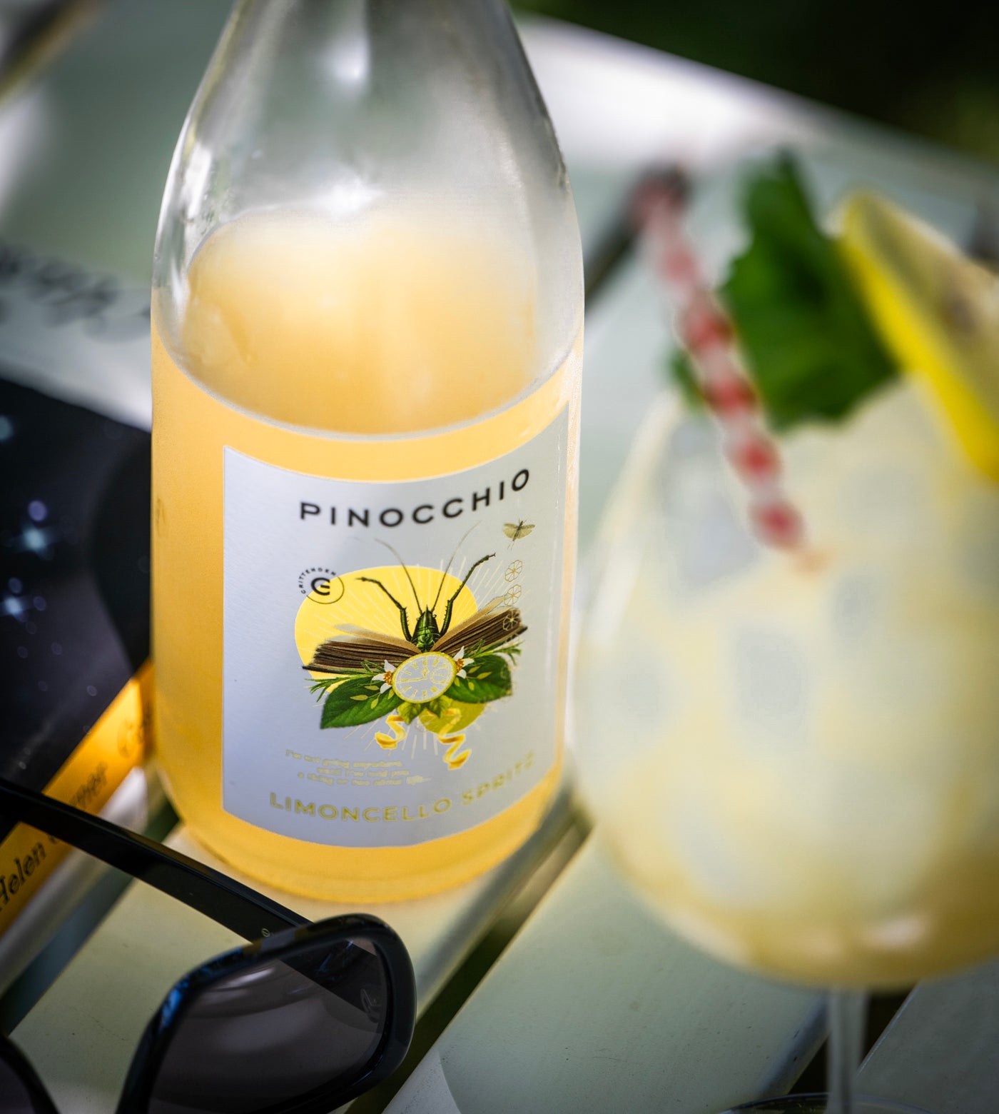 Bottle of Crittenden Pinocchio Limoncello with a glass of limoncello in the background