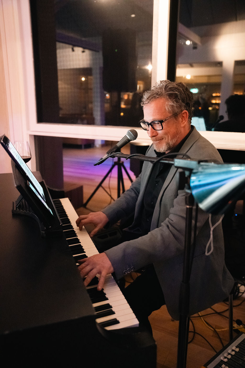 A pianist playing and singing at an evening function