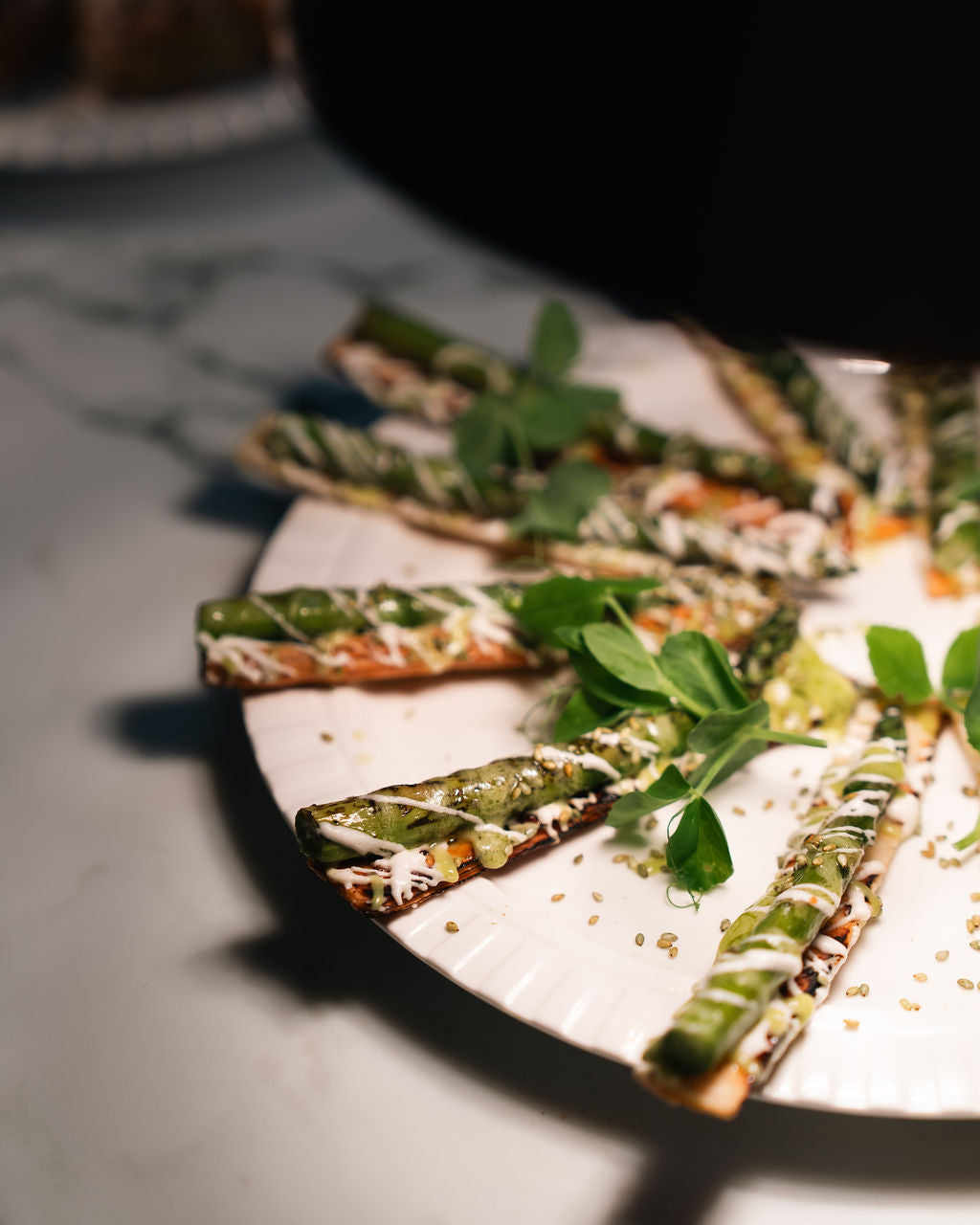 Grilled asparagus spears dressed with herbs on a plate