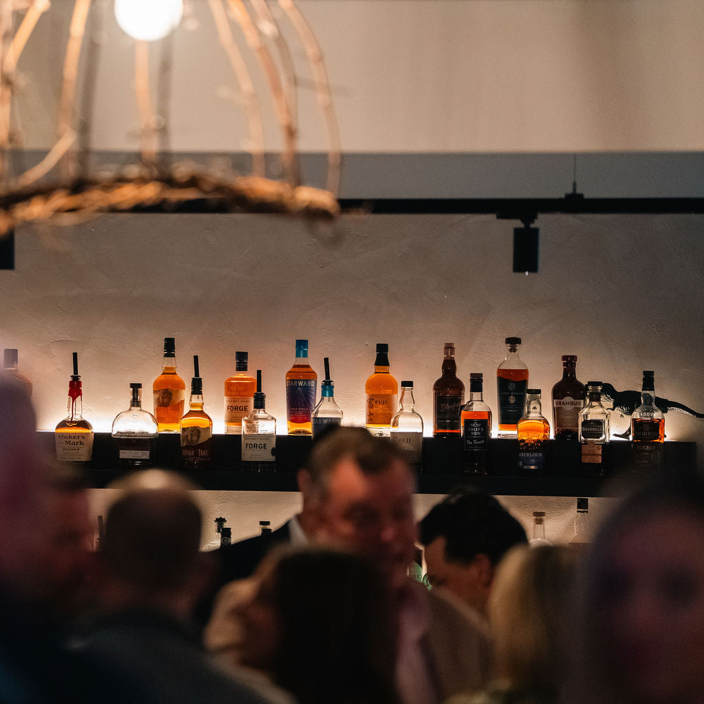 Guests mingling at the bar during an evening function