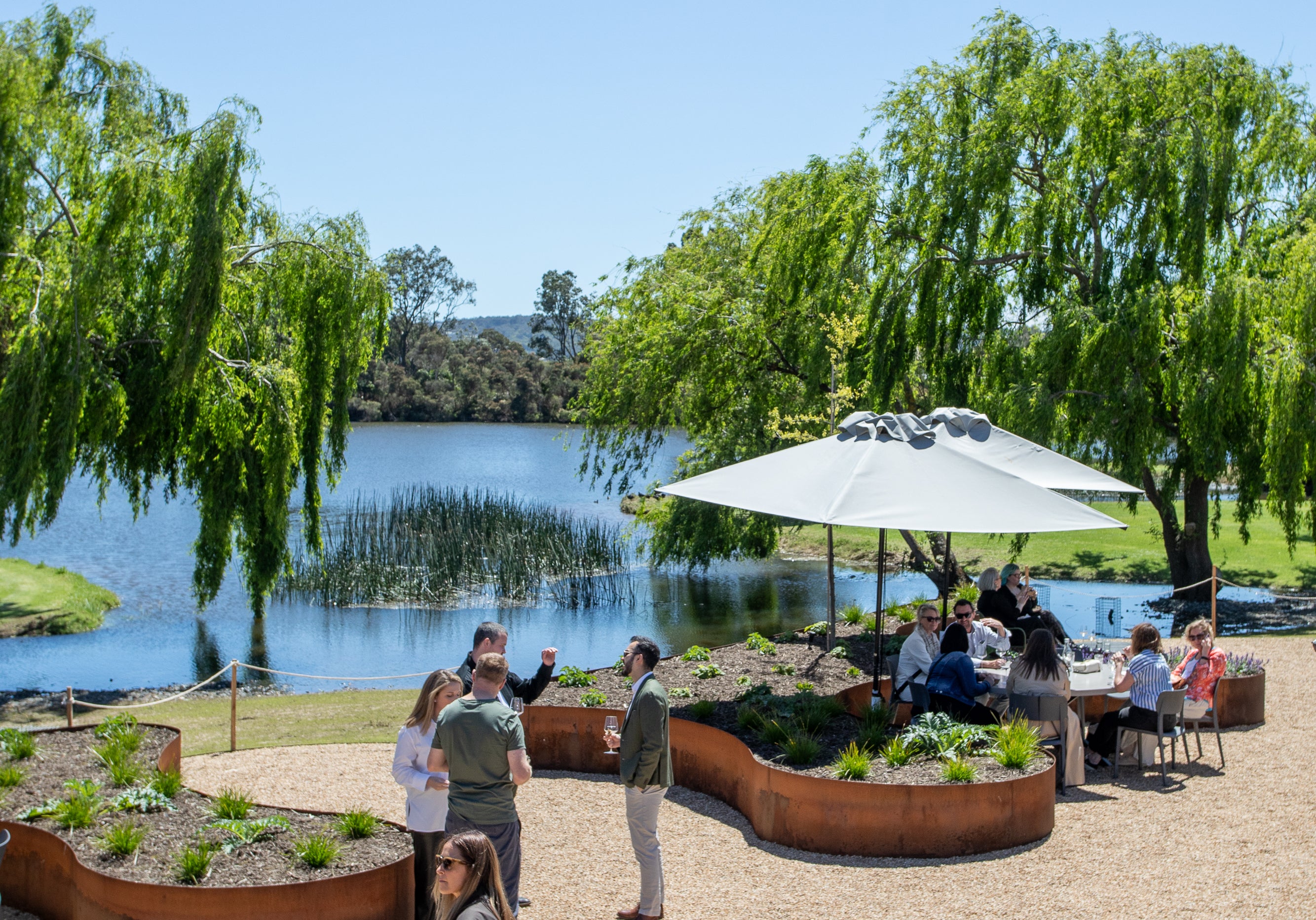 Guests arriving across the Terrace, with the lake and willows behind