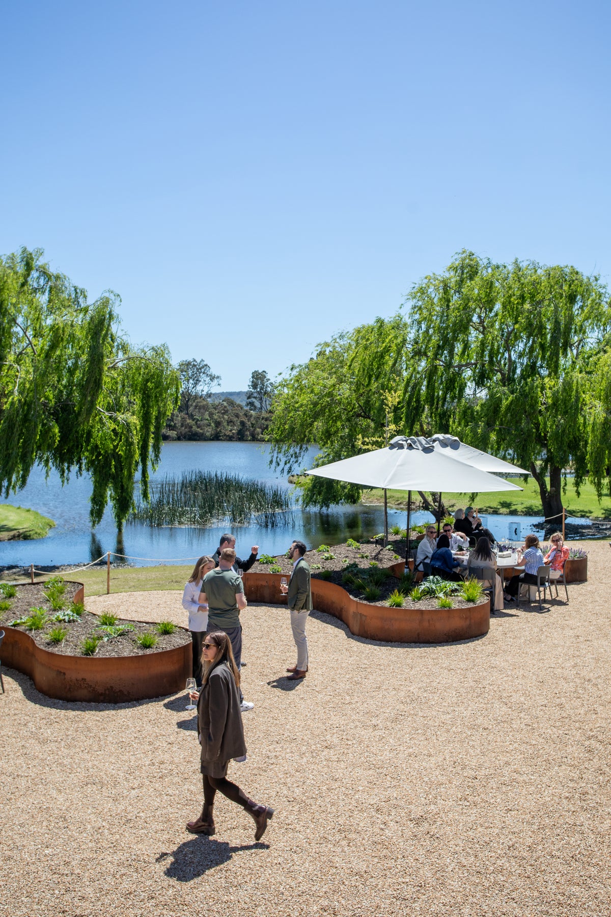 Guests arriving across the Terrace, with the lake and willows behind
