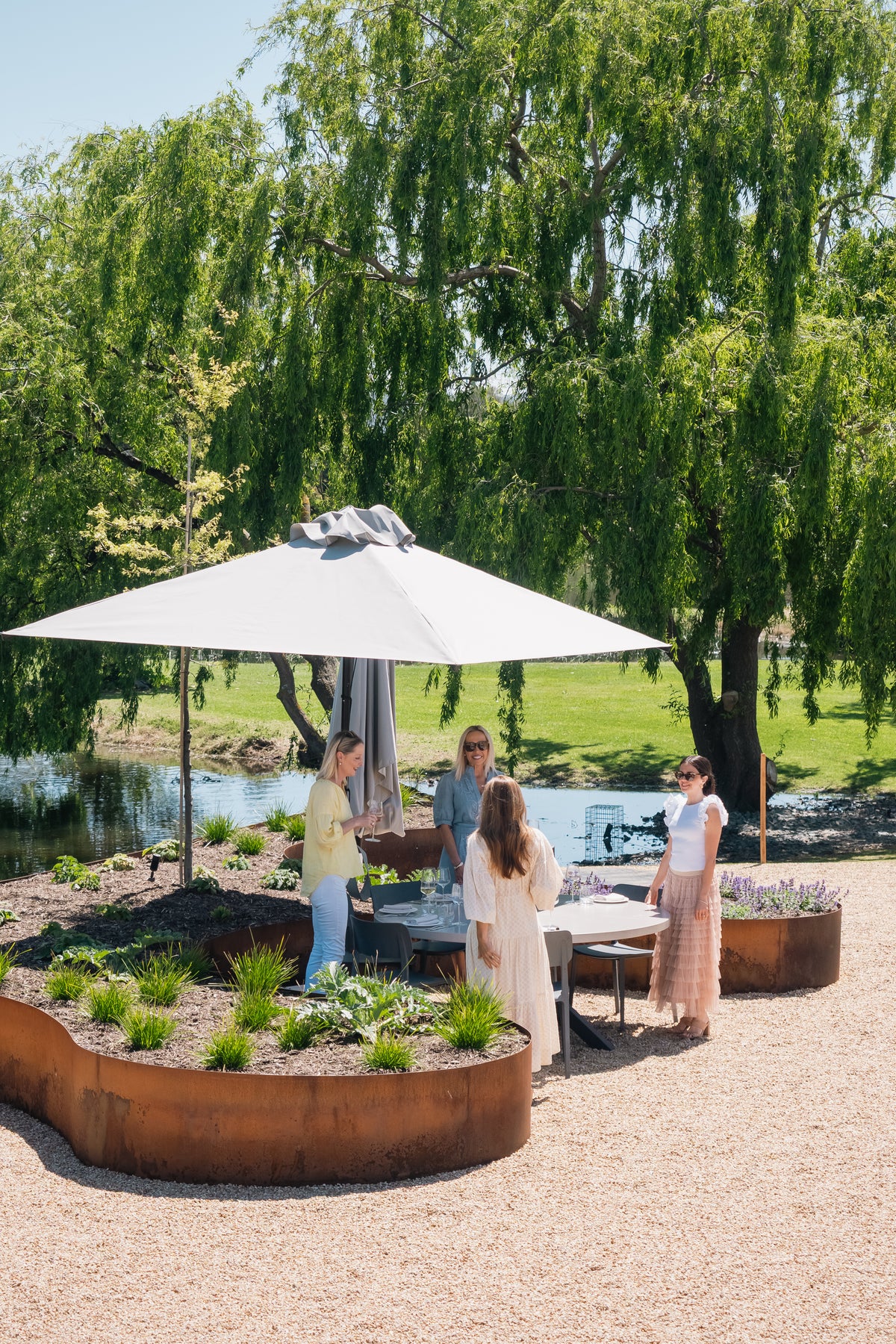 Guests on the Terrace by the lake, under a white umbrella
