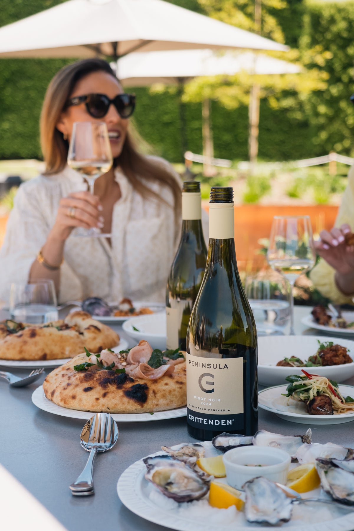 A guest enjoying oysters and white wine on the Terrace