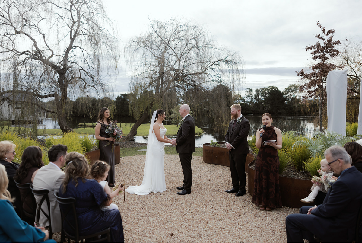 A bride and groom at their lakeside ceremony